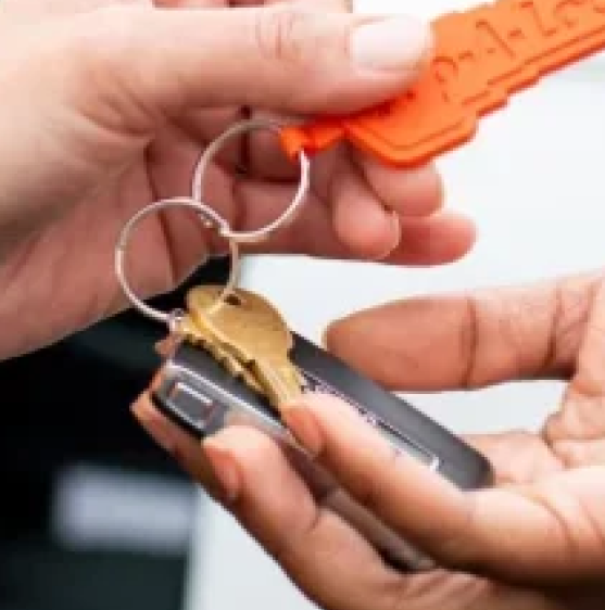 Pop-A-Lock Baton Rouge locksmith handing car keys to customer