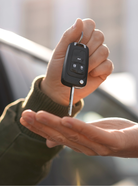 Car key fob being handed to a person