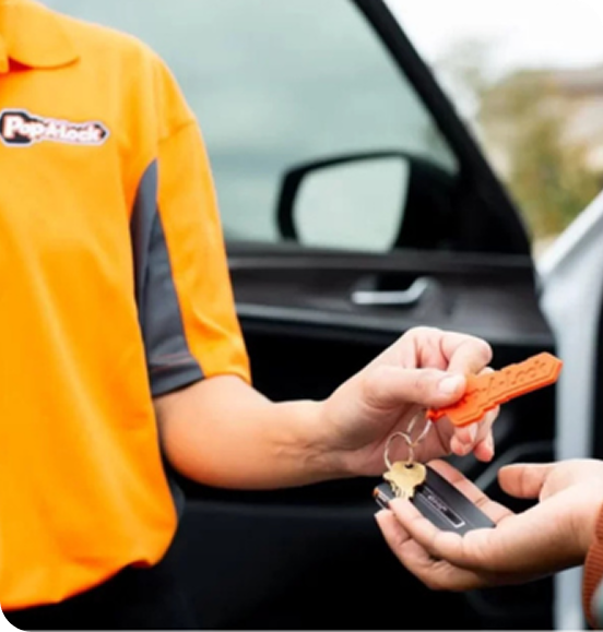 locksmith technician providing a car key replacement service to a customer