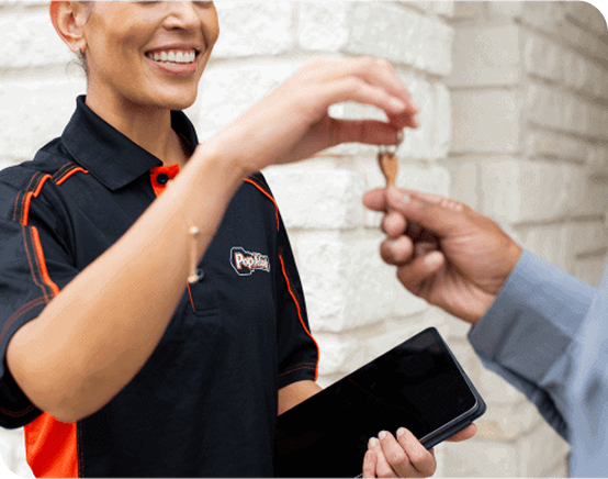 Locksmith handing door keys to home owner