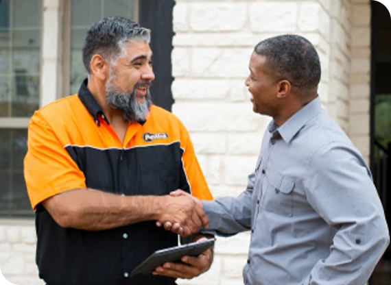Locksmith shaking hands with homeowner after service